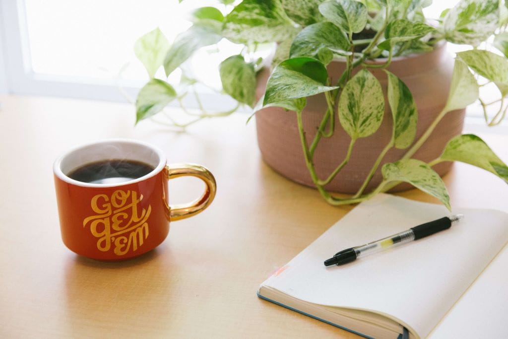 Decorative photo of a coffee mug with notebook