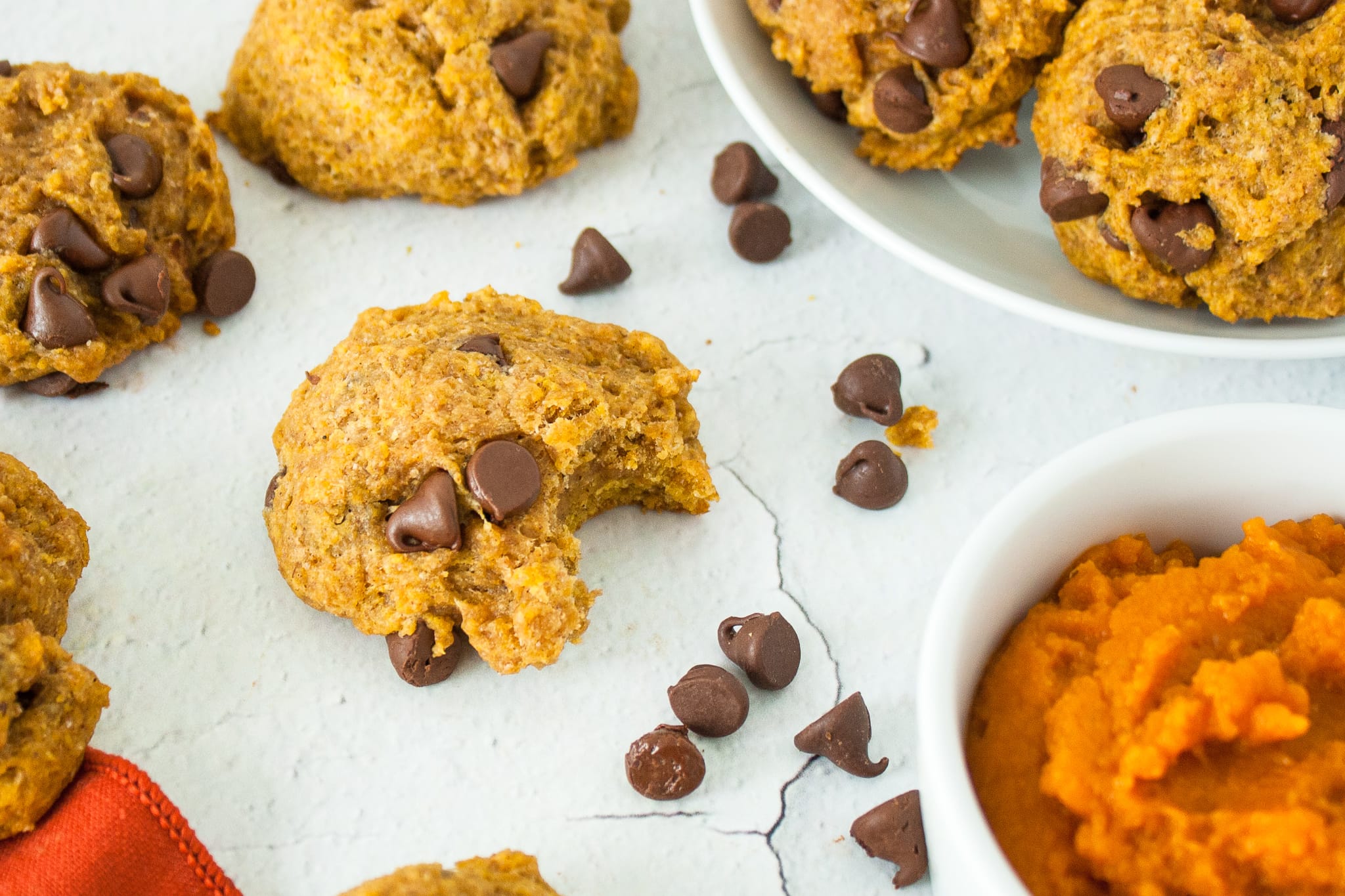 Close up photo of a cookie with a bite taken out of it.